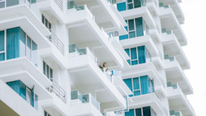 Man on High Rise Apartment Balcony