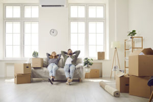 Couple relaxes on couch during move-in