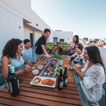 Rooftop Dining Party with grill in center also craft beer and wine.